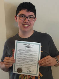 Conner sharing the Governor's proclamation of Usher Syndrome Awareness Day